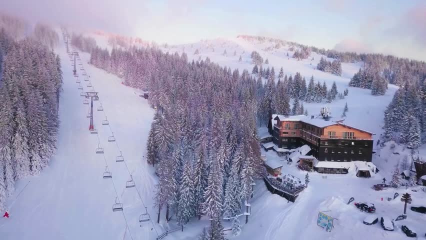 Aerial View of Ski Resort in Snowy Mountains Landscape