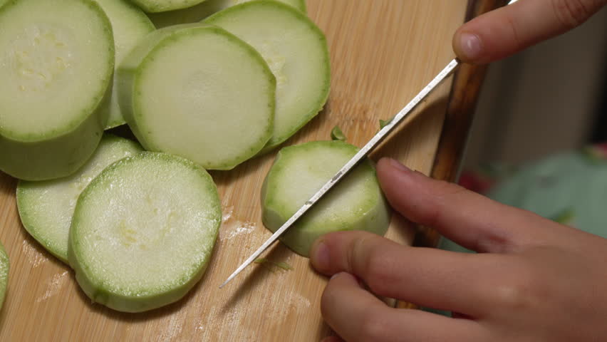 Squash Slicing Kitchen Child: Vegetable preparation, home cooking, knife skills.