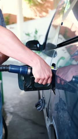 Car driver refueling his vehicle at a petrol station