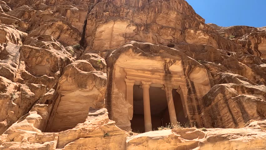 View of a rock-carved facade built into a mountain cliff in the ancient city of Petra, Jordan. - Powered by Shutterstock - Get 15% off with code: PIKWIZARD15