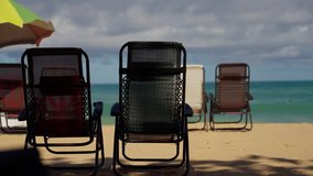 A Serene Beach Scene with Beach Chairs Awaiting Relaxation by the Ocean Waves Under a Cloudy Sky, Perfect for Vacationing and Enjoying Nature s Beauty - Powered by Shutterstock - Get 15% off with code: PIKWIZARD15