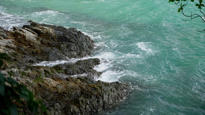 Tranquil Coastal Scene Featuring Rocky Shoreline and Gentle Waves, Capturing the Serenity and Beauty of Nature