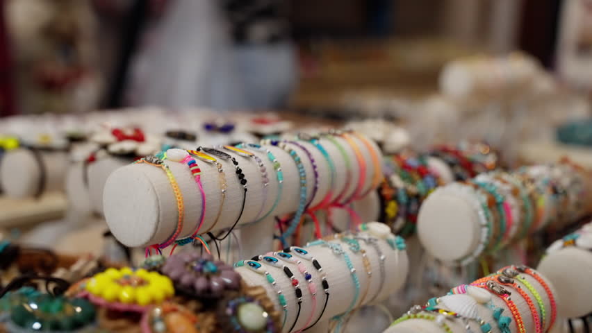 A Colorful Array of Handmade Bracelets Displayed at a Craft Fair, Featuring Unique Designs and Vibrant Beads, Capturing the Essence of Artisan Jewelry Craftsmanship