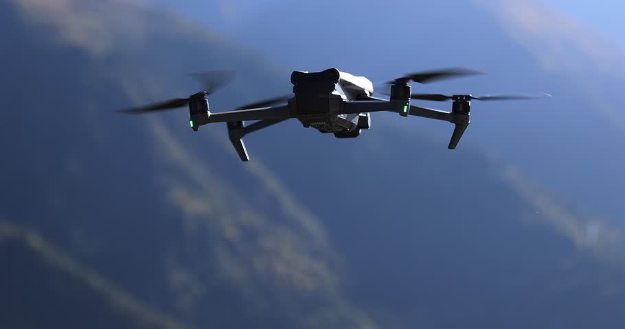 Flying drone taking off in summer grassland