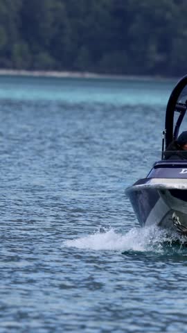 Jet boat speeds across Lake Glenorchy with passengers enjoying the scenic ride under clear skies