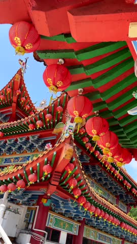 Close-up of traditional Chinese temple with vibrant red lanterns and ornate architecture at Thean Hou Temple in Kuala Lumpur, Malaysia. Ideal for travel, culture, and heritage themes.