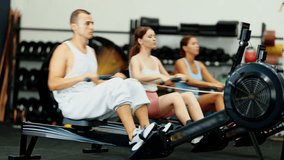 Young athletic man in sportswear training on rowing machine in gym - Powered by Shutterstock - Get 15% off with code: PIKWIZARD15