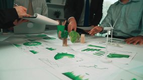 A diverse business team gathers in an office to discuss innovative strategies for sustainability, showcasing eco-friendly materials and renewable energy concepts. SACTR - Powered by Shutterstock - Get 15% off with code: PIKWIZARD15