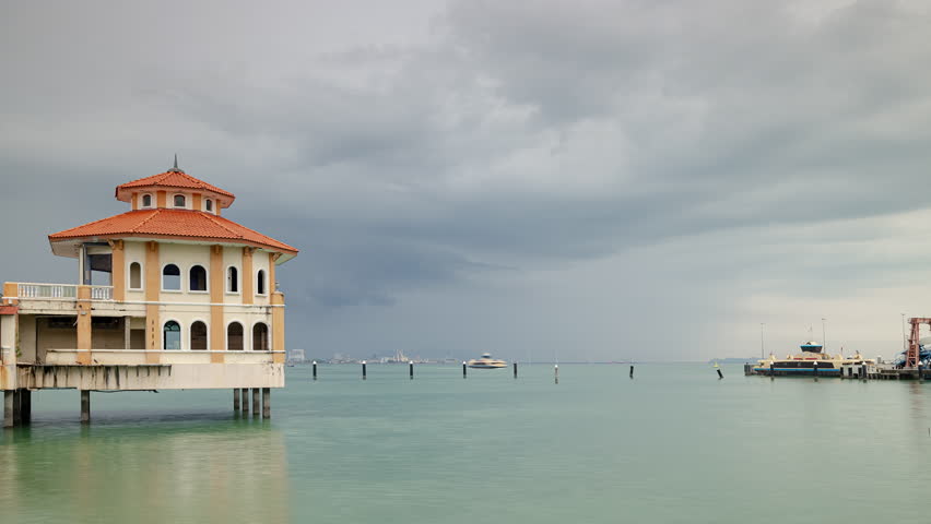 cloudy day storm sky george town famous ferry dock pier traffic bay panorama 4k timelapse penang malaysia