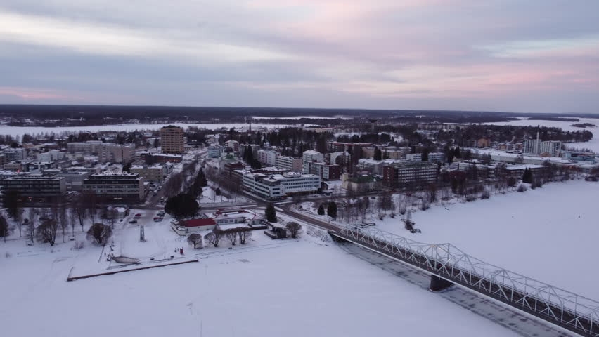 Bridge Over Frozen Torne River At Tornio City In Finland During Winter. Aerial Drone Shot