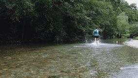 Male athlete running through a river in a lush forest, splashing water and showcasing determination and athleticism during a trail run amidst nature's beauty - Powered by Shutterstock - Get 15% off with code: PIKWIZARD15