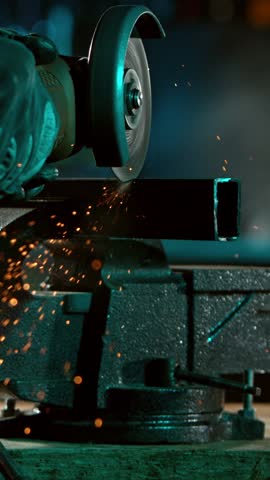 Super Slow Motion Of Cutting Iron Tube With Flex saw. Hard Working In Heavy Industry, Worker In Workshop. Low Depth Of Focus. Filmed On High Speed Cinema Camera, 1000 fps. Vertical Aspect Ratio.
