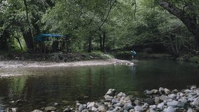 Male athlete running through a river in a lush forest, splashing water and showcasing determination and athleticism during a trail run amidst nature's beauty - Powered by Shutterstock - Get 15% off with code: PIKWIZARD15