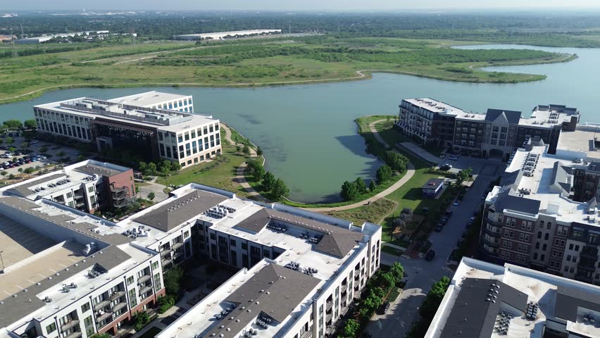 New construction apartment building complex with courtyard, resort style swimming pool, luxury amenities, rooftop garage parking in master-planned Cypress Waters suburb Dallas Fort Worth, Texas. USA