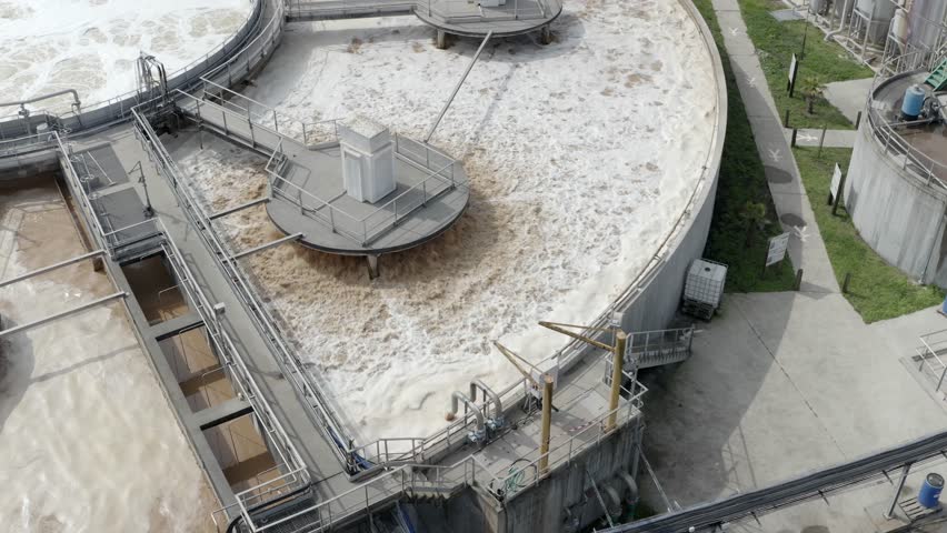Aerial close-up view of water aeration process in circular treatment tank at industrial facility, Veille-Saint-Girons, France