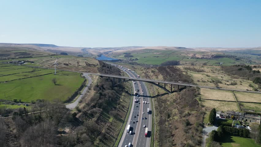 An aerial view of the Scammonden Bridge over the M62 Motorway with Booth Wood Dam in the backgorund in Huddersfield, West Yorkshire, England