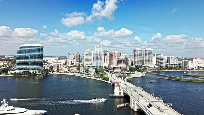 Pan drone shot of cityscape with Royal Park Bridge, One Flagler and Phillips Point building in West Palm Beach, Florida, USA