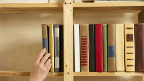 Timelapse reader hand taking books from bookshelf, woman putting books in row on shelf in bookcase - Powered by Shutterstock - Get 15% off with code: PIKWIZARD15