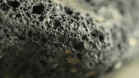 Crumbly dark lava rock macro with porous crust detail - Powered by Shutterstock - Get 15% off with code: PIKWIZARD15