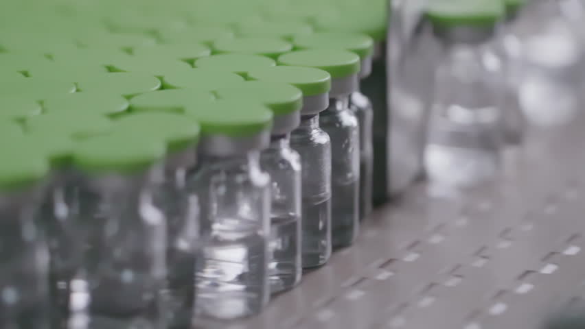 Pharmaceutical medicine bottles on a production line in a clean laboratory environment, ensuring safety and quality control in a modern factory