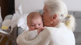 Embracing the toddler. Grandmother with cute toddler baby at home. - Powered by Shutterstock - Get 15% off with code: PIKWIZARD15