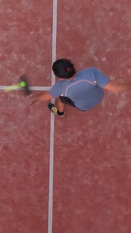Vertical, Top view of a paddle tennis student learning to play on an outdoor court