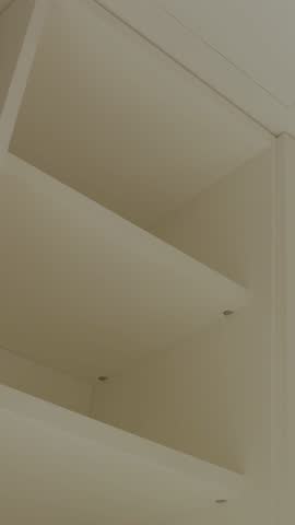 Empty wardrobe shelves as key elements of modern interior design. Vertical shot. 