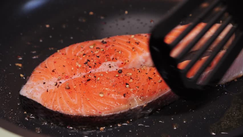 Grilled salmon steaks on the pan. Freshly cooked fish fillet. Food concept. High quality 4k footage