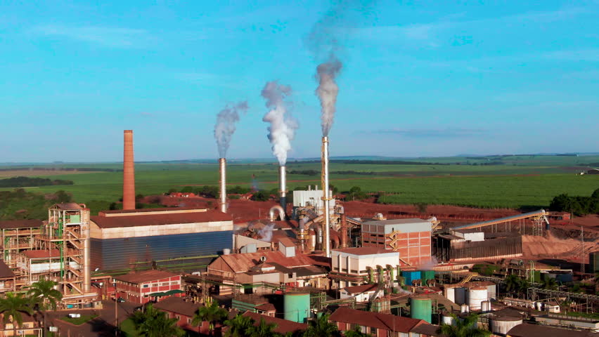 Ethanol production plant with smoking chimneys and factory buildings in the background
