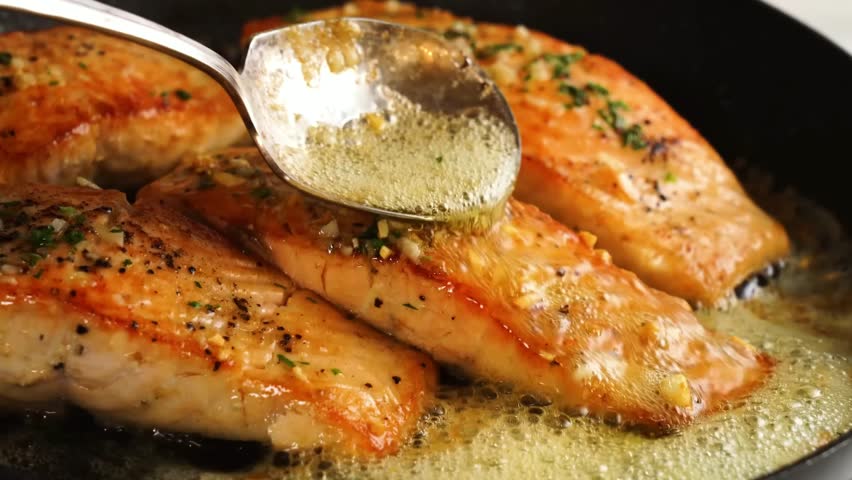 Garlic butter salmon seared to perfection, rich in flavor with herbs and lemon — a gourmet seafood dish ideal for fine dining visuals, culinary shoots, luxury meals, and restaurant presentations.