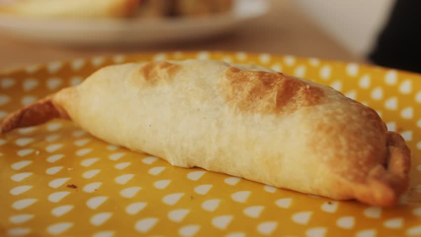 Woman eating empanadas argetinian pie, Samosa tart, traditional bakery from argentina, chef filling dough in home with meat and vegetables, homemade spanish empanadas