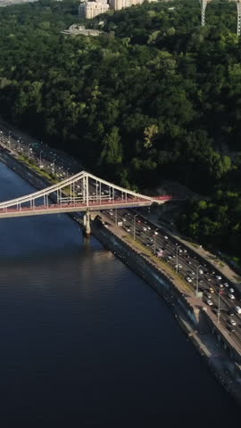 Vertical Format Video of Bridge Aerial With City Traffic at Sunset. Traffic heavy, Intensive Traffic in the streets of Kiev. Traffic highway. Kiev panorama Ukraine