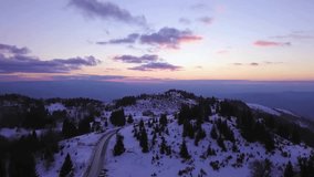 Aerial View of Winter Sunset Over Snowy Mountain Range and Winding Road - Powered by Shutterstock - Get 15% off with code: PIKWIZARD15