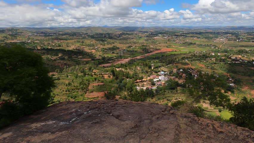 Woman tourist admires stunning panorama of Antananarivo surroundings from Royal Palace Rock in Madagascar