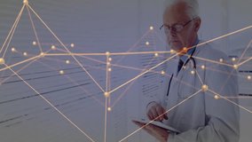 Senior doctor studying tablet data and interacting with glowing network graph for medical analysis. Healthcare, data visualization, telemedicine, digital health, medical technology, professional, - Powered by Shutterstock - Get 15% off with code: PIKWIZARD15