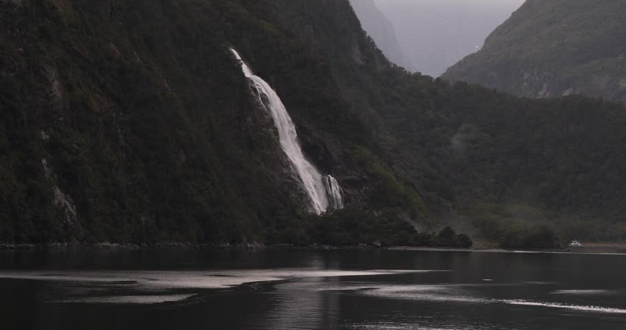 Stiff cliffs and waterfall at Milford Sound (Piopiotahi), Fiordland National Park on the South Island of New Zealand.