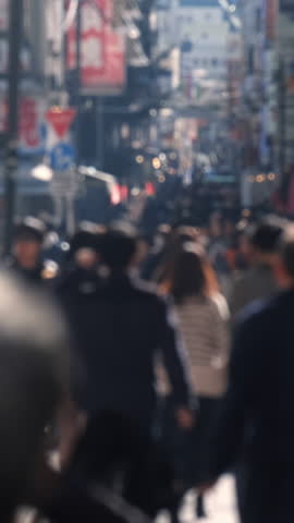 Slow motion crowd of people walking on street.