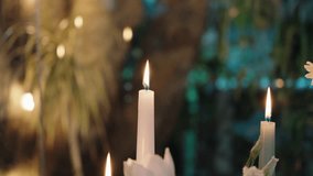 flames of white candles flickering in warm dreamy garden setting during evening - Powered by Shutterstock - Get 15% off with code: PIKWIZARD15