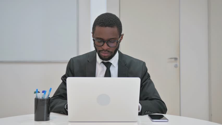 Businessman Left Office Desk with Laptop and Phone