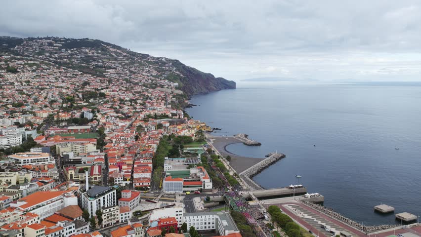 Funchal, Madeira, Portugal, exploring the city from above, enjoying the breathtaking aerial view of the coastline. Aerial, Dolly Back