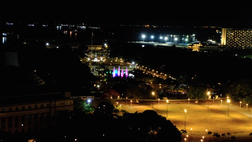 Scenic aerial view of Rizal Luneta Park at night with water fountain and changing coloured lights in capital city Manila Philippines
