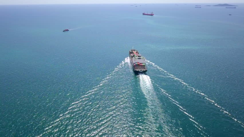 Cargo ships carry containers and sail the seas delivering goods to various places around the world.