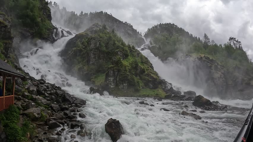 A majestic view of Latefossen waterfall surrounded by vibrant greenery in western Norway. Famous nature attraction
