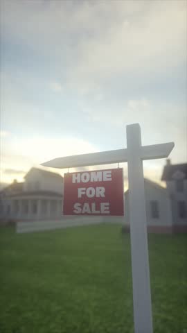 Real Estate Sign With Home for Sale in Suburban Neighborhood at Sunset