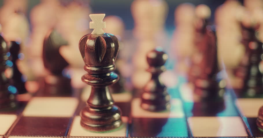 Close-Up of Chess Board with Wooden Pieces – Strategic Game Concept. Cinematic close-up shot of a classic wooden chess board with detailed chess pieces arranged for play. Intelligence, strategy