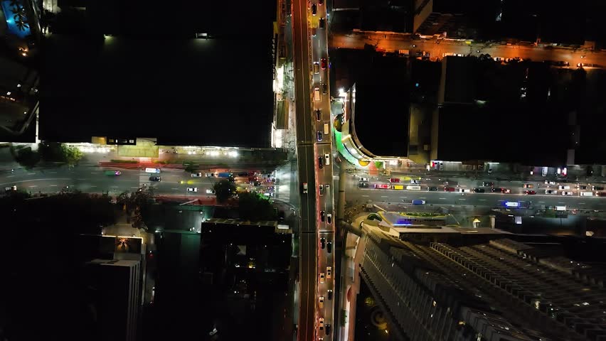Downtown with cars and vehicles on highways in Makati. Night view in Metro Manila. Philippines.