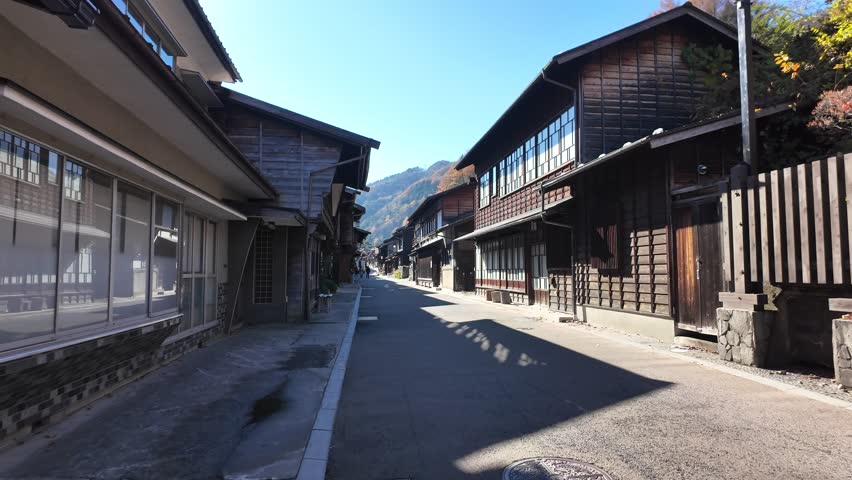 POV Along Scenic view of traditional wooden buildings in Narai-Juku, a historic Japanese post town.