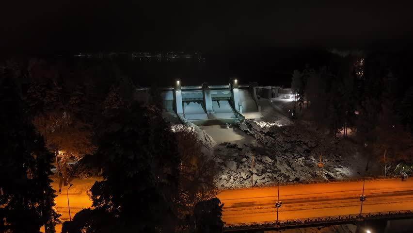 Drone approaching the Imatrankoski dam, winter evening in Imatra, Finland