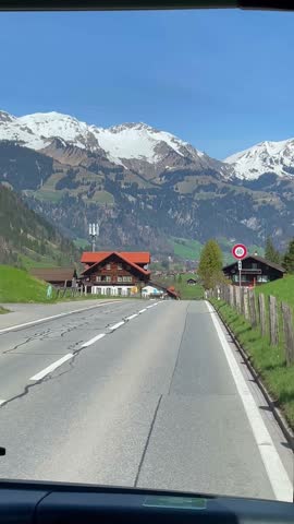 Landscape of green fields on a nature road in Switzerland.	