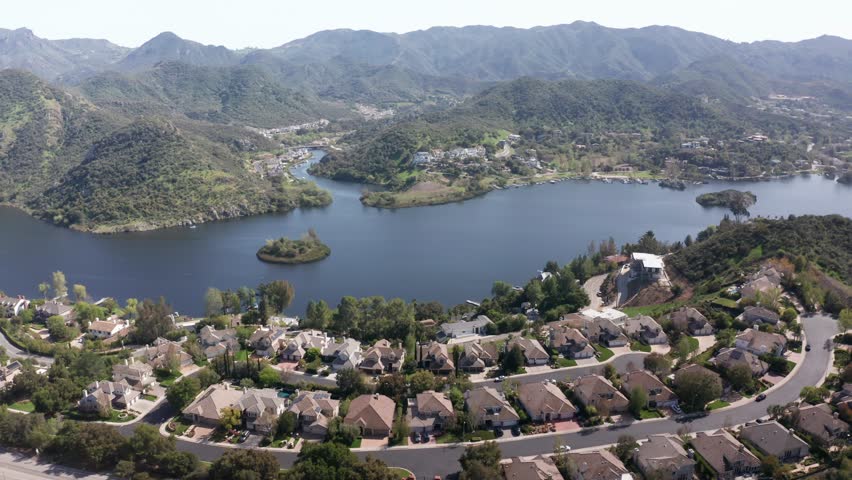 Aerial wide panning shot of the upscale lakefront community of Lake Sherwood, California. 4K at 30 FPS